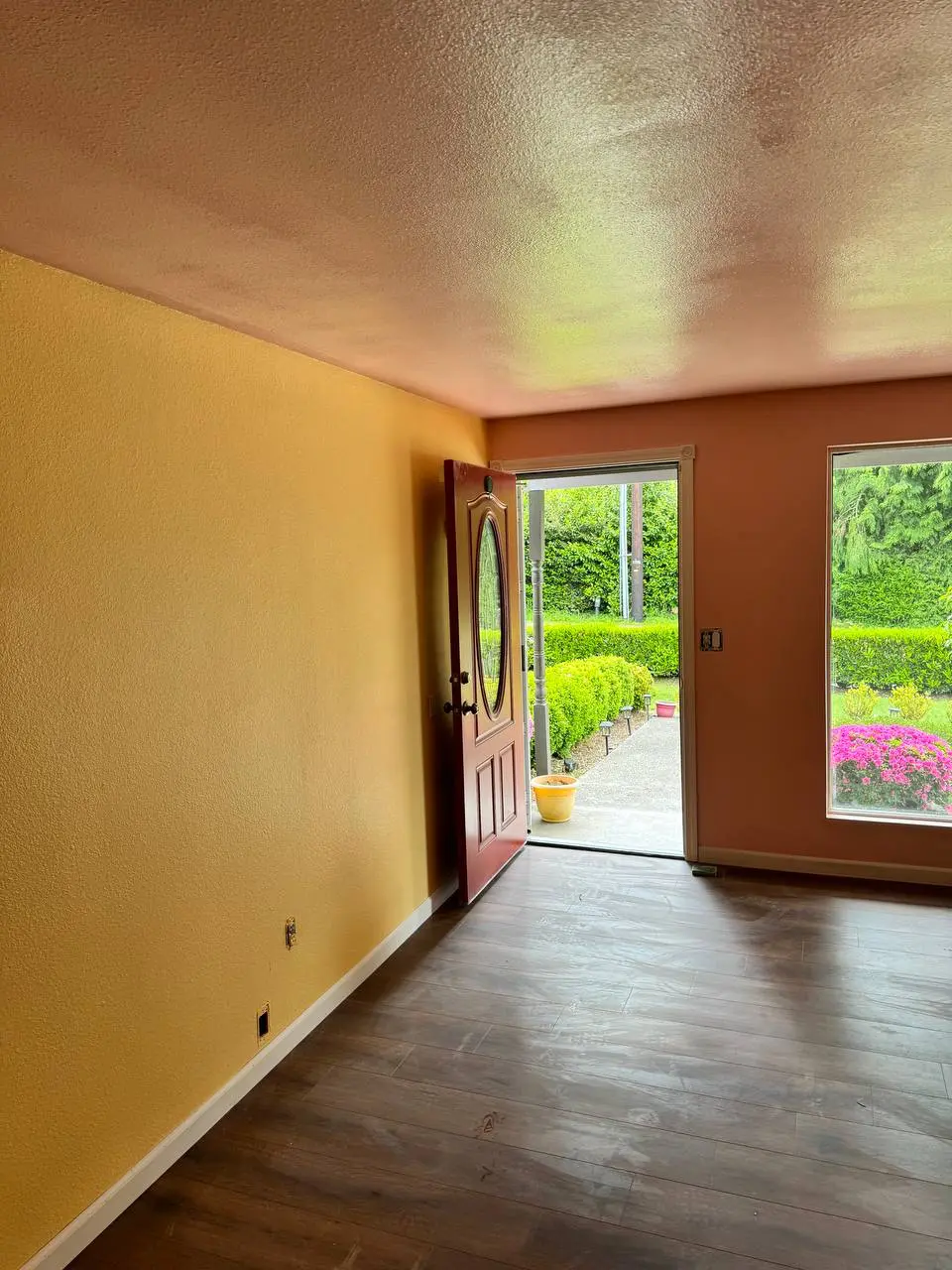 Creative wall painting with bright yellow entryway and outdoor view in Shoreline