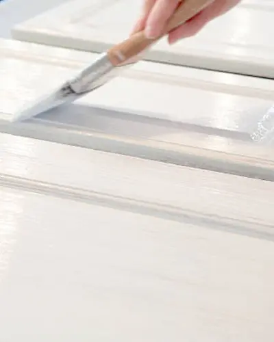 Professional kitchen cabinet painting process in Renton workshop showing spray booth and precision techniques