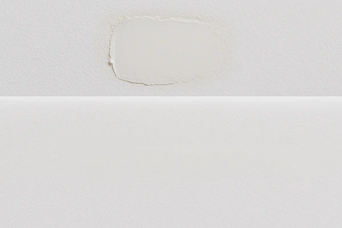 Comparison showing visible DIY patch edges versus invisible professional feathering in Renton drywall repair